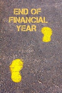 Yellow footsteps on sidewalk towards End of Financial Year message