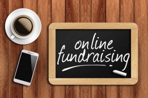 coffee, phone  and chalkboard with word online fundraising